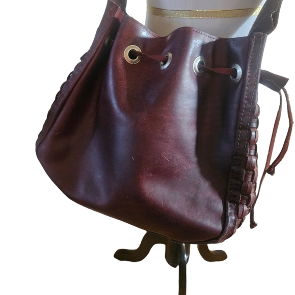 Handbags - Vintage leather draw string bucket bag with a woven leather accent.